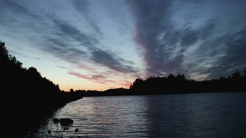 Waves of the pond and sunset dramatic sky late at night Stock Footage 121455035