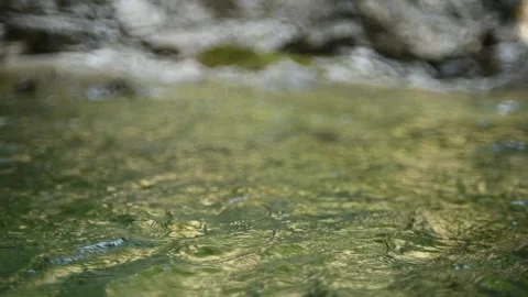 Waves on the pond of a mountain stream (abstract, slow motion) Video stock 260844359