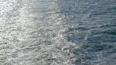 Waves produced by the engine of a ship traveling in the sea. Video stock 144335373