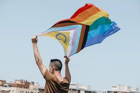 Waves a progress pride flag in the air Stock Photos