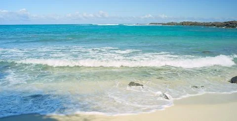 Waves Pusing In and Out on Shore of White Sandy Beach Stock Photos