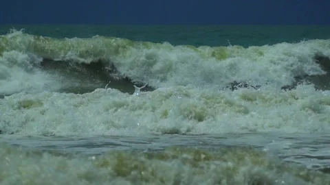 Waves in the raging sea in slow motion, in the background gloomy sky 動画素材 226896793