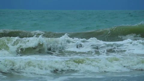 Waves in the raging sea in slow motion, in the background gloomy sky 動画素材 226896908
