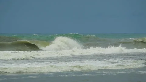 Waves in the raging sea in slow motion, in the background gloomy sky 動画素材 226897063