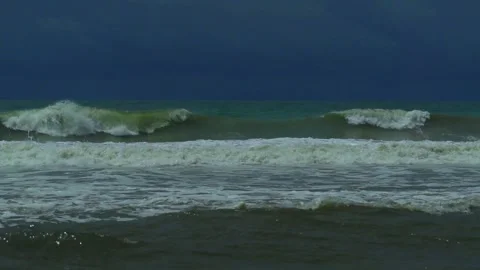 Waves in the raging sea in slow motion, in the background gloomy sky 動画素材 226897102