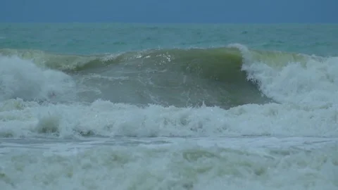 Waves in the raging sea in slow motion, in the background gloomy sky 動画素材 226897487