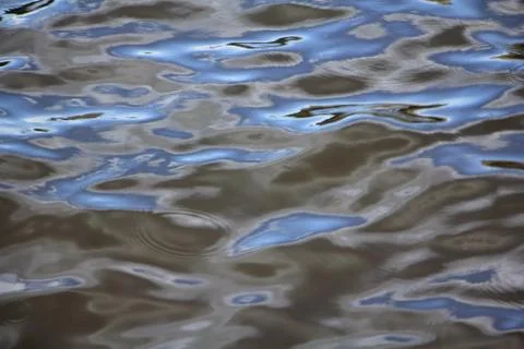 Waves from raindrops on the waves of the river Stock Photos