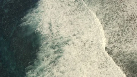 Waves reach the shore, repeating themselves endlessly. Dron. Aerial. Stock-Footage 199479976