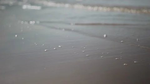 Waves reaching beach shore in slow motion Stock Footage 95272775