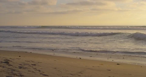 Waves reaching the beach at sunset Stock Footage 96376076