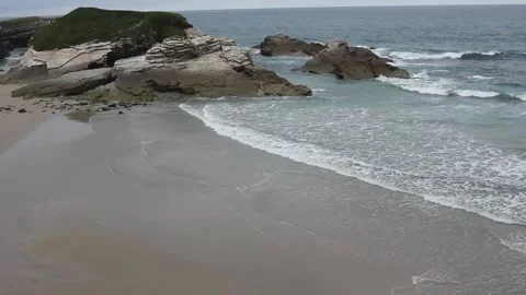 Waves reaching a Cantabrian beach in Ribadeo at sunset Stock Footage 306706654