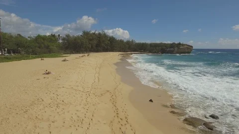 Waves reaching on sandy beach on a sunny day Stock Footage 104936424