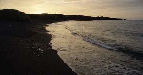Waves reaching the sea coast at sunset Stock Footage 96464547