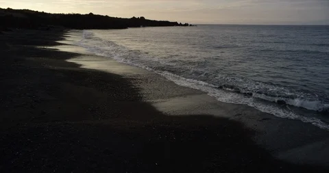 Waves reaching the sea coast at sunset Stock Footage 96464963