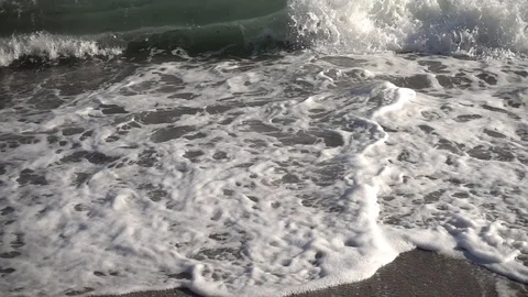 Waves reaching the shore of the beach in slow motion Stock Footage 129651433