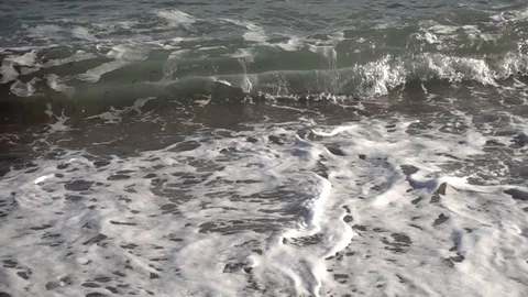 Waves reaching the shore of the beach in slow motion Stock Footage 129651524