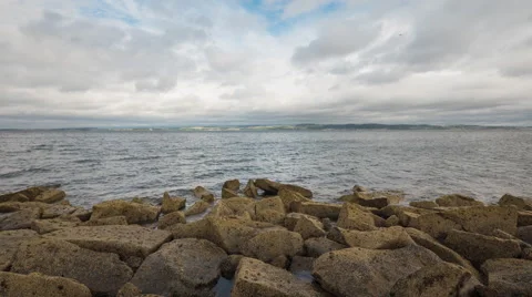 Waves reaching a stone pier at the Edinburgh's coastline - Time Lapse Stock Footage 61563950