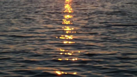 Waves with the reflection of the setting sun in the water. Stock Footage 233578210