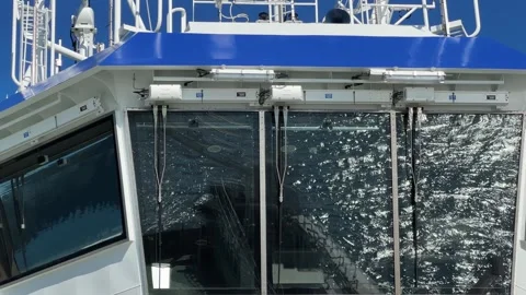 Waves reflection with sun glints on car ferry wheelhouse window Stock Footage 345665427