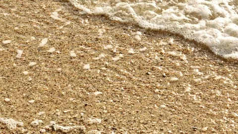 The waves retreating along the shore in slow motion. Stock Footage 307775589