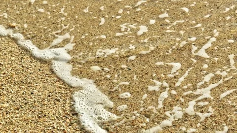 The waves retreating along the shore in slow motion. Stock Footage 307775615