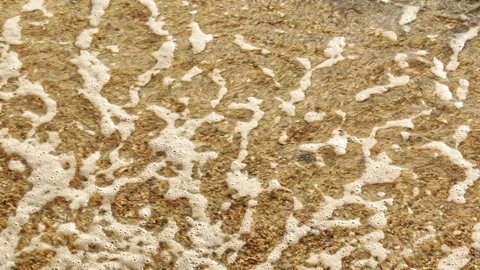 The waves retreating along the shore in slow motion. Stock Footage 307775670