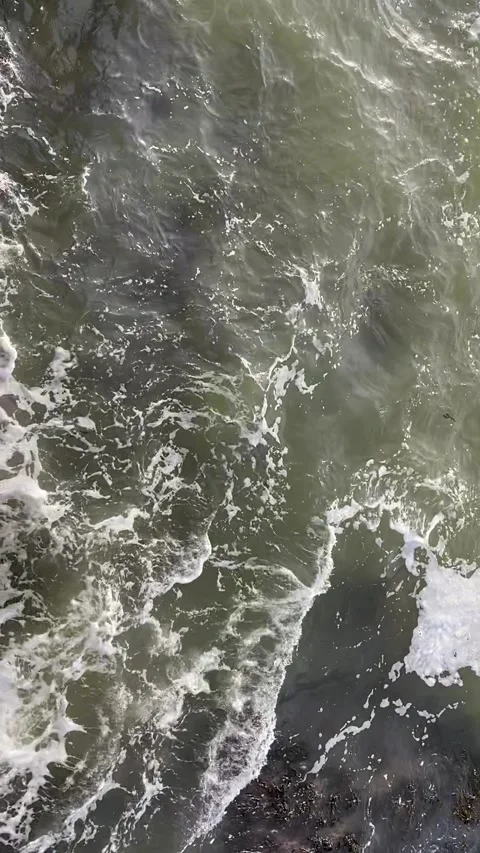 Waves rippling against rocks Stock Footage 169036576