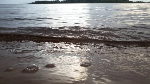 Waves on the river bank. Sandy river bank. Stock Footage 107625264