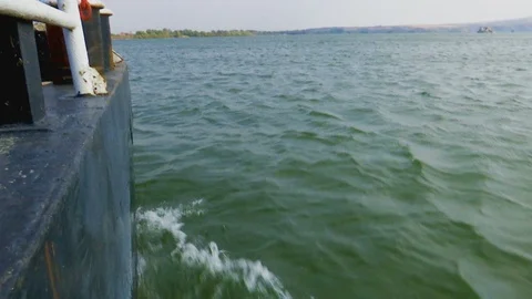 Waves on the river caused by the ship Stockbeeldmateriaal 96592893