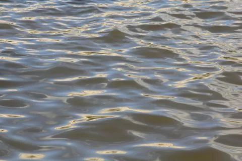 The waves of the river, decorated with the sun Stock Photos