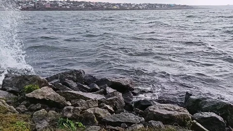 The waves of the river hit the stones on a cloudy day. Stock Footage 119804387