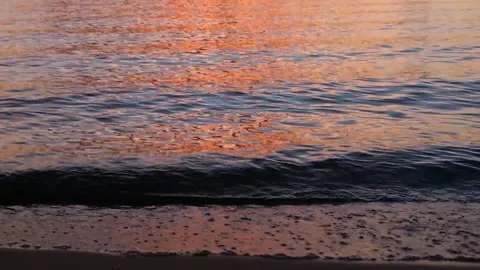 Waves on the river in the rays of sunset against the background of clouds. Stock Footage 202717407