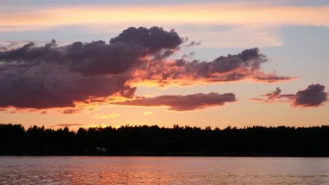 Waves on the river in the rays of sunset against the background of clouds. Stock Footage 202717409