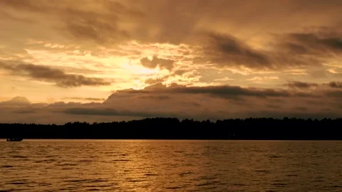 Waves on the river in the rays of sunset against the background of clouds Stock Footage 202717631