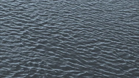 The waves on the river smoothly create the texture of the water. calm water Stock Footage 198685282