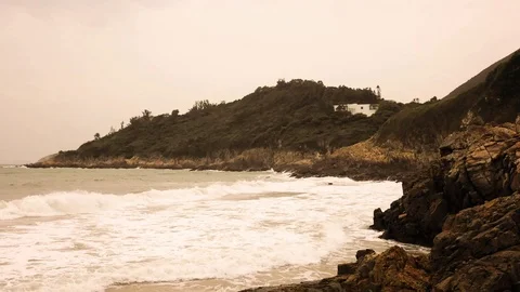 The waves on the rocks and beach at Big Wave Beach in Hong Kong at sunrise Stock Footage 119469961