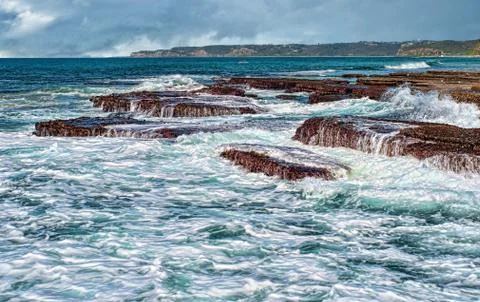 Waves on rocks at the coast Stock Photos