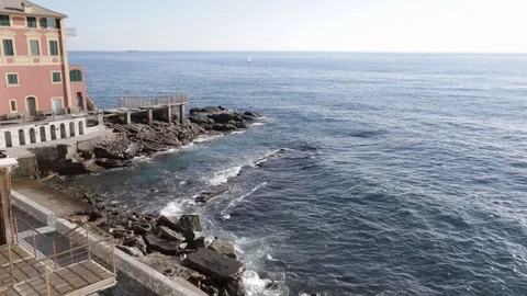Waves on the rocks in front of the bathhouse and house Stock Footage 103436832