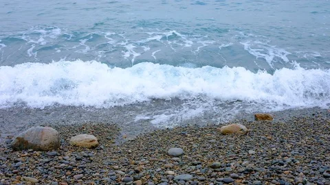 The waves on the rocky beach close up view Video stock 88104763