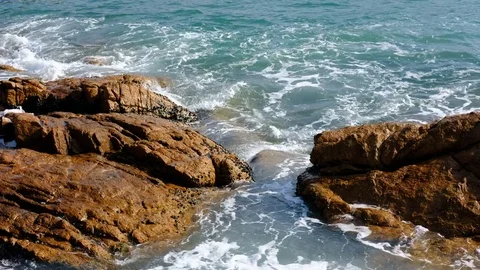 Waves on rocky beach Stock Footage 83867645