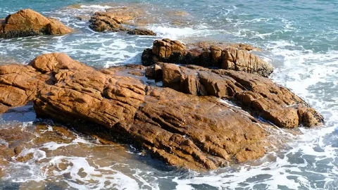 Waves on rocky beach Stock Footage 83867649
