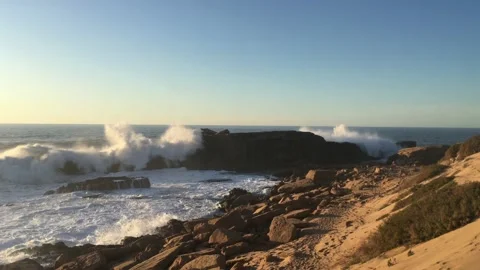Waves at the rocky beach in warm evening light Video stock 236842201
