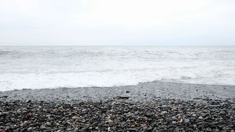 Waves at a rocky beach on a windy day by the sea Video stock 122275321