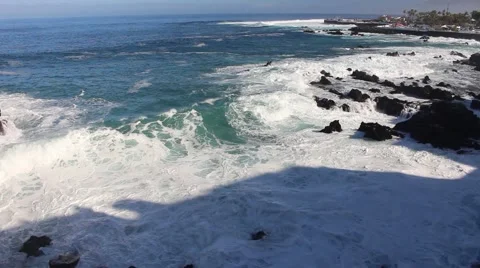 Waves roll in across volcanic rocks Stock Footage 61317030