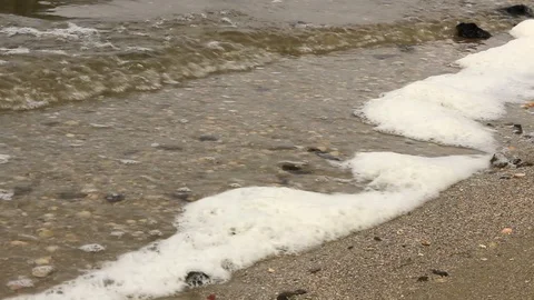 Waves roll on the bank of the river and beat stones with foam Stock-Footage 118744717