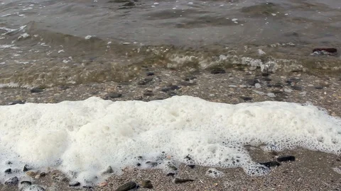 Waves roll on the bank of the river and beat stones with foam Stock-Footage 118744719
