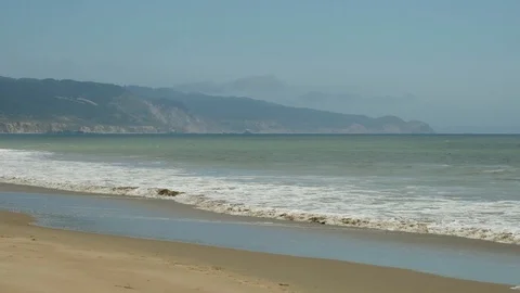 Waves roll onto beach 9353 스톡 동영상 93326274