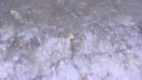 Waves roll on a beach of pebbles Stock Footage 80356794