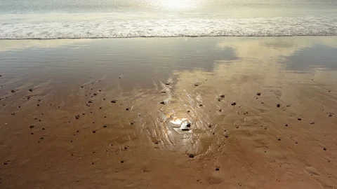 Waves roll beautifully onto a sandy beach Stock Footage 128210745