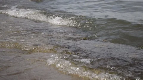 Waves roll on a concrete beach in windy weather Stock Footage 232337422